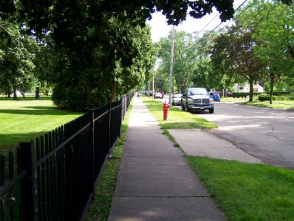 Sidewalk ride past Kemper Center