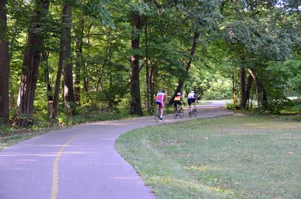 Three cyclists on North Branch Trail after Golf Road