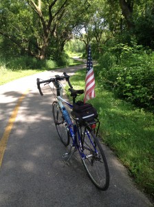 Bike and US flag on bike trail on Independence day.